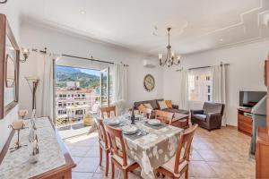 a dining room and living room with a table and chairs at Casa Paqui in Port de Soller