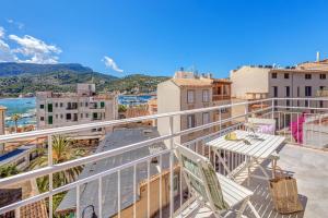 a balcony with a table and chairs on a building at Casa Paqui in Port de Soller