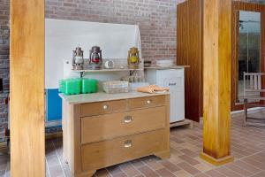 a kitchen with a wooden dresser and a stove at Ferienwohnung Junge 1 in Lohe-Rickelshof +25 photos