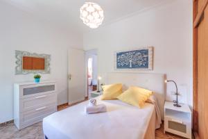 a white bedroom with a bed and a sink at Casa Paqui in Port de Soller