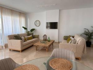 a living room with two couches and a coffee table at Apartamento Puerto Sotogrande in Sotogrande