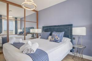 a bedroom with a large bed with towels on it at Luxury Tarifa in Tarifa +22 photos