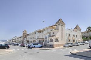 a street with cars parked in front of buildings at Luxury Tarifa in Tarifa