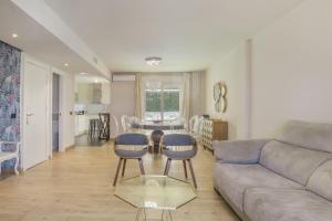 a living room with a couch and a table and chairs at Luxury Tarifa in Tarifa