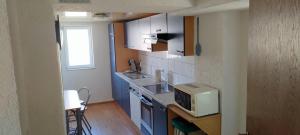 a small kitchen with blue cabinets and a microwave at Peter in Michelstadt
