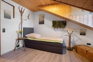 a bedroom with a bed in a room at Weitsicht in Weiler-Simmerberg