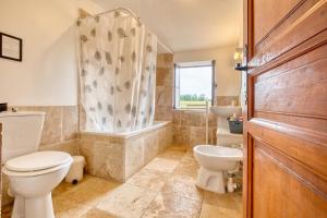 a bathroom with a toilet and a tub and a sink at Le Chai in Razac-dʼEymet +25 photos