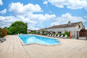a swimming pool in front of a house at Le Chai in Razac-dʼEymet