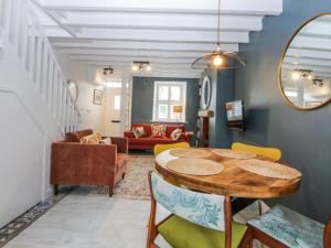 a living room with a table and chairs at East meets West in Criccieth