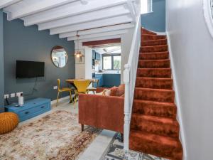 a staircase in a living room with a couch at East meets West in Criccieth