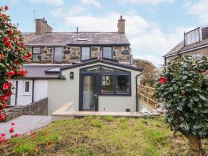 a detached house with a front door and windows at East meets West in Criccieth