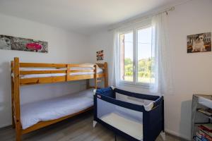 a bedroom with two bunk beds and a window at Gite La Salamandre in Saint-André-dʼAllas