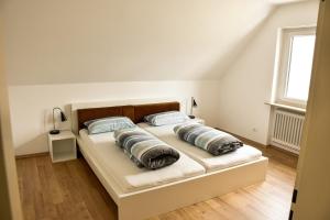 a bedroom with a bed with two pillows on it at am Hohlebach in Schliengen