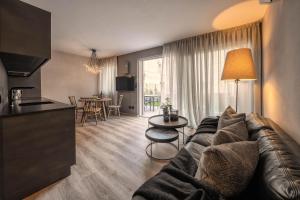 a living room with a couch and a table at Lores Loft in Merano