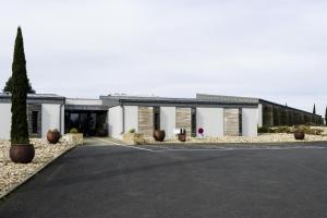 a building with a parking lot in front of it at Domaine du Boisniard in Chambretaud