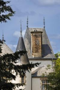 a building with a clock tower on top of it at Domaine du Boisniard in Chambretaud