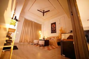 a living room with a bed and a dining room at Lux 1bhk with balcony in Noida