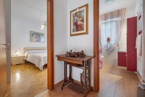 a bedroom with a bed and a table and a mirror at Camera Meridiana in Roncone
