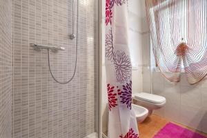 a bathroom with a shower with a toilet and a shower curtain at Camera Meridiana in Roncone