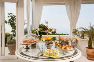 a buffet of food on a table with a window at Tenuta Del Poggio Antico in Ischia