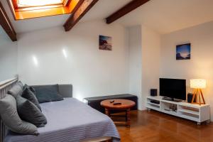a living room with a bed and a tv at Maison Roxane in Six-Fours-les-Plages
