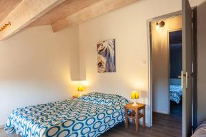 a bedroom with a bed and two lamps on tables at Maison Roxane in Six-Fours-les-Plages +17 photos
