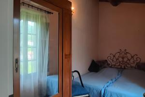 a bedroom with a bed next to a window at Villa con parco e piscina-Camaiore in Nocchi +60 photos