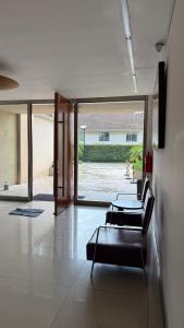 a living room with a table and chairs and a large window at 01 Tigre Stays in Tigre