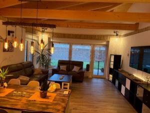 a living room with a couch and a table at Villa Toscana in Teltow