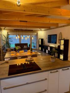 a kitchen with a counter top and a living room at Villa Toscana in Teltow