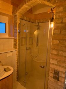 a glass shower in a bathroom with a sink at Villa Toscana in Teltow +26 photos