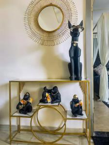a shelf with a mirror and some figurines on it at Lux 1bhk with balcony in Noida