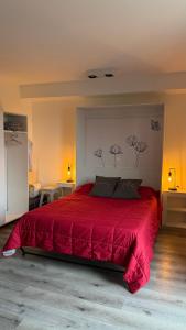 a bedroom with a large red bed with red sheets at 01 Tigre Stays in Tigre +18 photos
