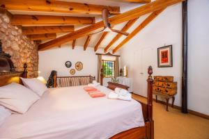 a bedroom with a large bed with white sheets at Sa Cabana d'es Vicari in Fornalutx
