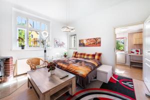 a bedroom with a bed and a table in a room at Fewo mit Terrasse Moritzburg in Moritzburg +27 photos