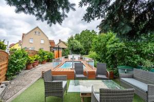 a backyard with a pool and a table and chairs at Fewo mit Terrasse Moritzburg in Moritzburg
