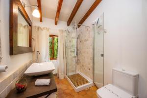 a bathroom with a shower and a toilet and a sink at Sa Cabana d'es Vicari in Fornalutx +26 photos