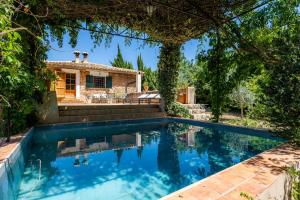 a swimming pool in front of a house at Sa Cabana d'es Vicari in Fornalutx
