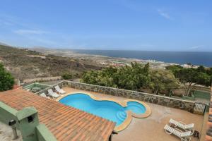 a swimming pool on the roof of a house at Casa Rural Tijoco in Adeje