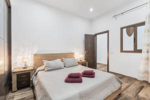 a bedroom with a large bed with two towels on it at Casa Rural Tijoco in Adeje +17 photos
