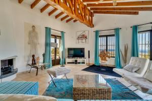 a living room with a couch and a tv at Villa Amalia in Denia
