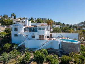 an aerial view of a white house with a swimming pool at Villa Amalia in Denia