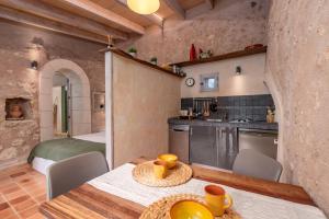 a kitchen and dining room with a table and chairs at Casa Groc in Costitx +14 photos