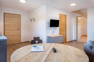 a room with a wooden table with a book on it at Nigglhof Apartment Katarina in Redagno