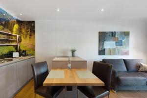 a living room with a table and a couch at Hawerländer Apartments in Schmallenberg +50 photos
