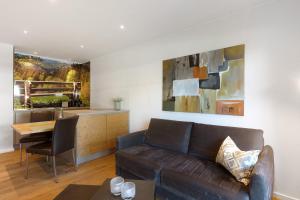 a living room with a couch and a table at Hawerländer Apartments in Schmallenberg