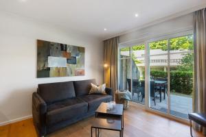 a living room with a couch and a table at Hawerländer Apartments in Schmallenberg