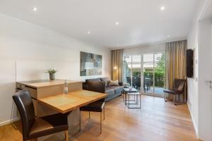 a living room with a table and a couch at Hawerländer Apartments in Schmallenberg