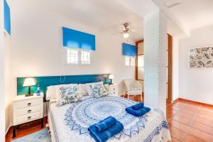 a bedroom with a bed with blue pillows on it at Villa Tessa in Marbella +19 photos