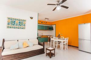 a living room with a couch and a kitchen at Piccola casa Marina in Villa San Pietro